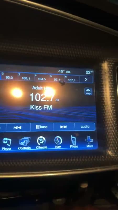 Customer testimonial - 2013 Dodge Charger owner on camera entering the radio code into his Uconnect TM9 radio, radio playing again